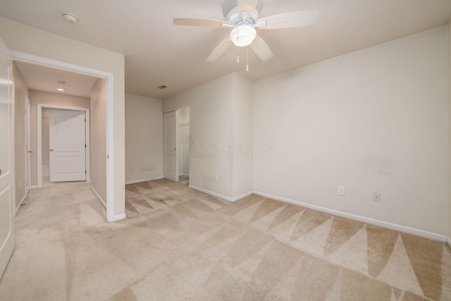 interior space with ceiling fan and light colored carpet