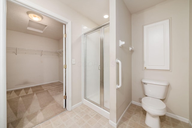 bathroom featuring toilet and walk in shower