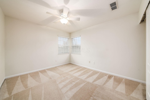 spare room featuring carpet floors and ceiling fan