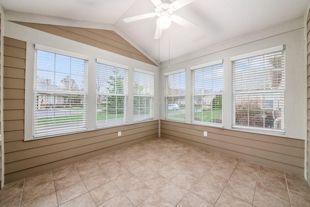 unfurnished sunroom featuring ceiling fan and vaulted ceiling