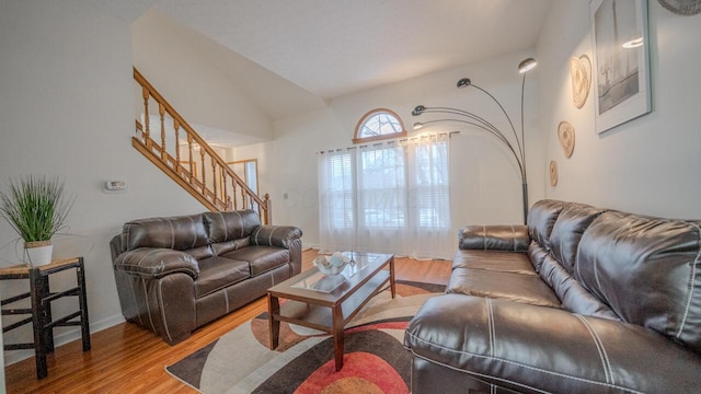 living room with vaulted ceiling and light hardwood / wood-style floors