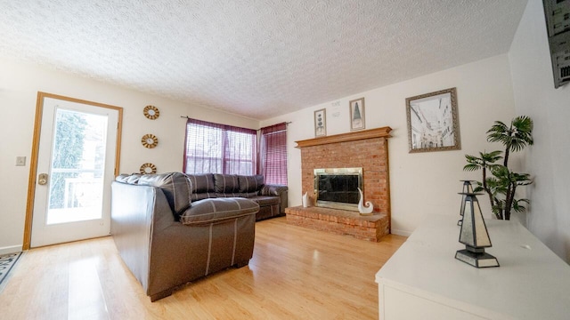 living room featuring hardwood / wood-style floors, a textured ceiling, and a wealth of natural light