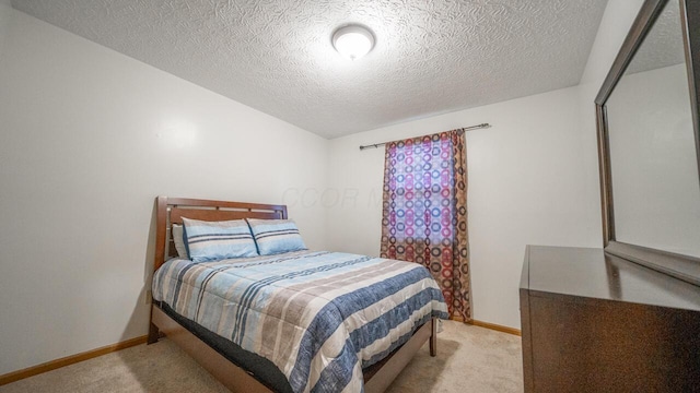 carpeted bedroom featuring a textured ceiling