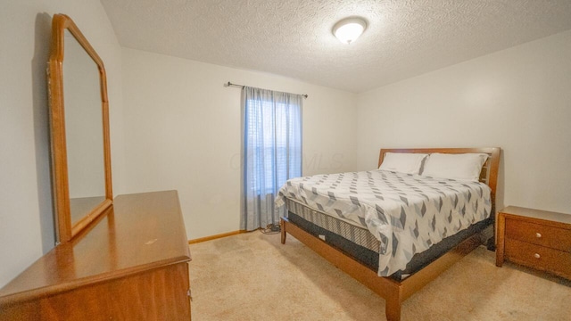 carpeted bedroom featuring a textured ceiling