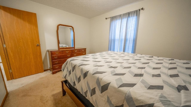 carpeted bedroom with a textured ceiling