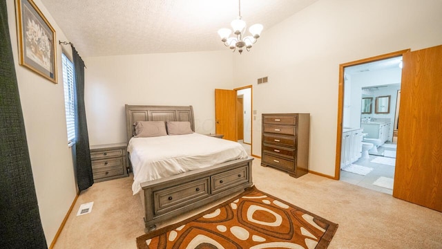 bedroom featuring high vaulted ceiling, ensuite bathroom, a notable chandelier, a textured ceiling, and light carpet