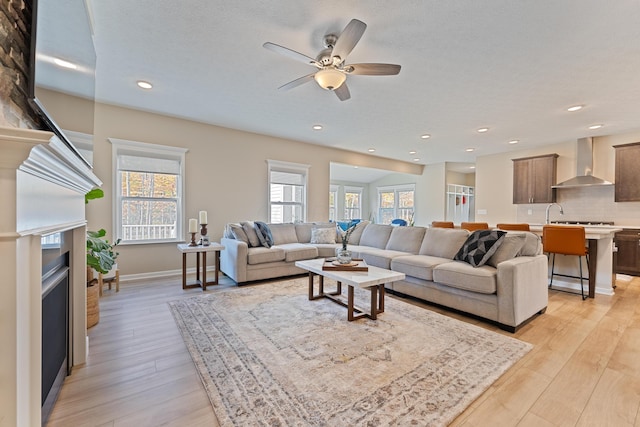 living room featuring ceiling fan and light wood-type flooring