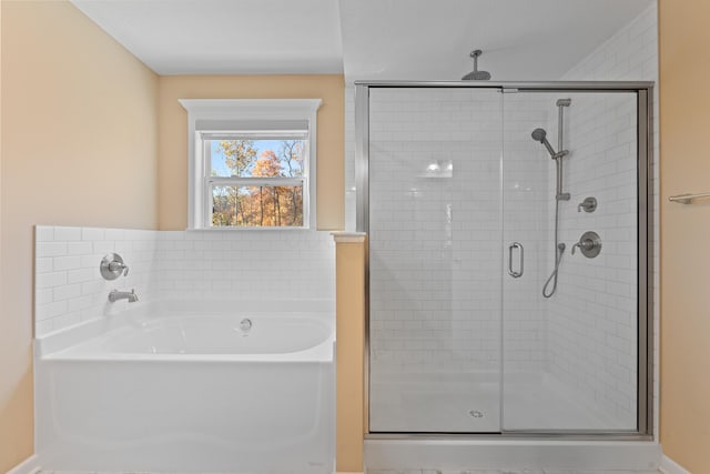 bathroom with separate shower and tub