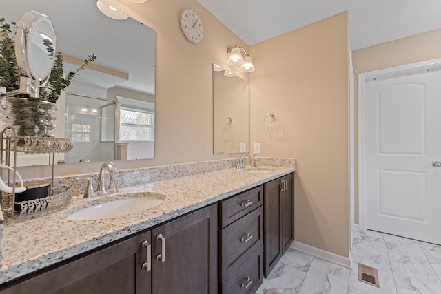 bathroom with vanity and a shower with door