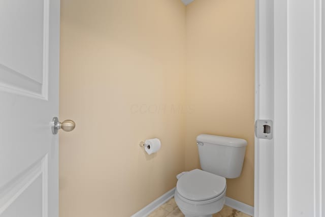 bathroom featuring toilet and tile patterned flooring