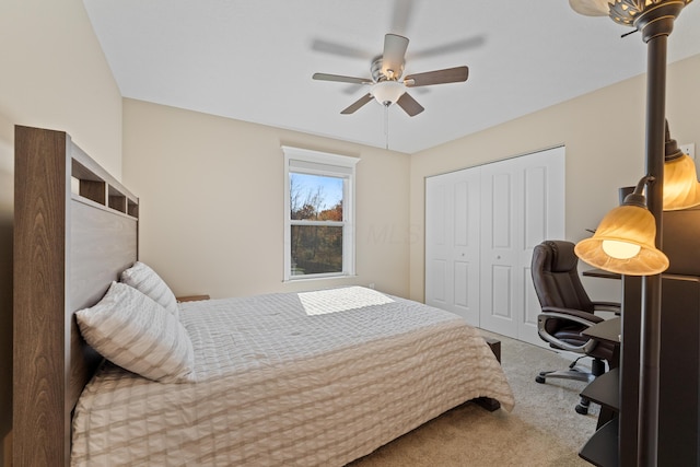 carpeted bedroom featuring ceiling fan and a closet