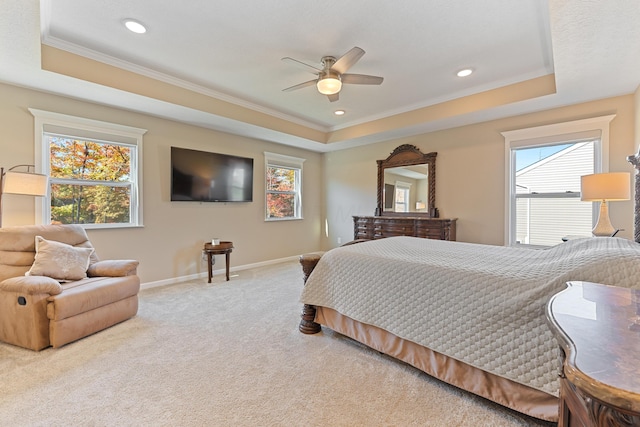 carpeted bedroom with ceiling fan, crown molding, and a raised ceiling