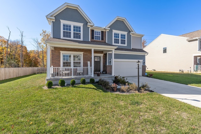 view of front of property featuring a garage, a front lawn, and a porch