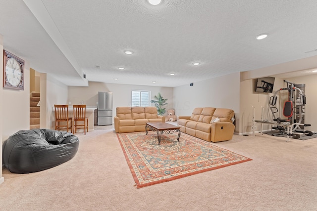 carpeted living room featuring a textured ceiling