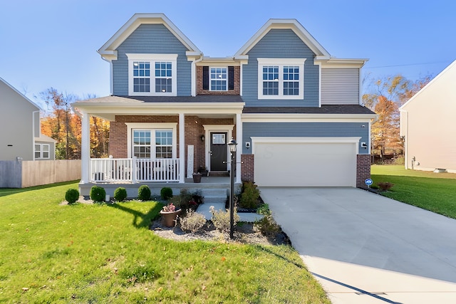 view of front of home featuring a front yard, a garage, and a porch