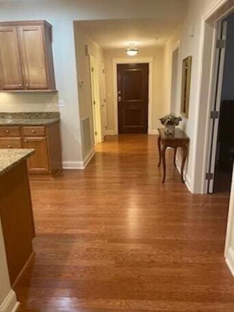 5735 Newbank Cir Unit 208, Dublin, OH 43017 - hallway featuring dark hardwood / wood-style floors