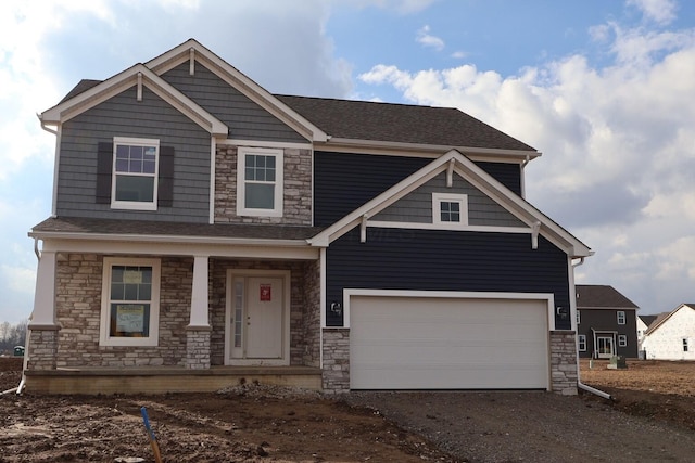 craftsman inspired home featuring dirt driveway, covered porch, and a garage