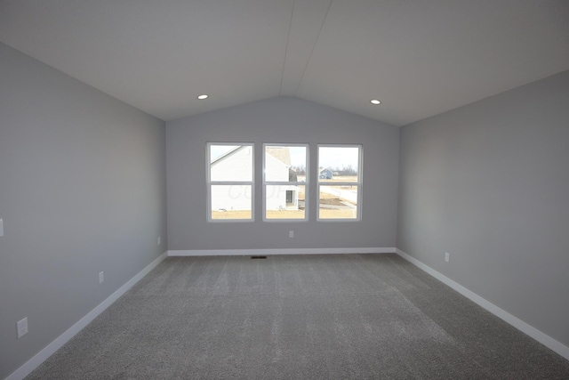 unfurnished room featuring carpet, vaulted ceiling, baseboards, and recessed lighting