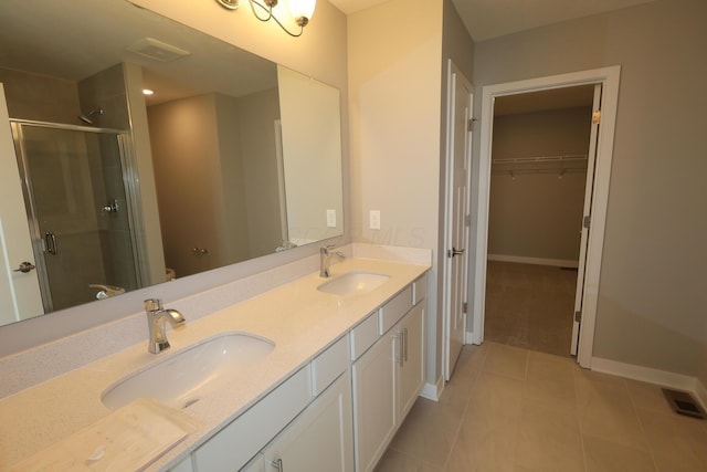 full bath featuring double vanity, a stall shower, a sink, and visible vents