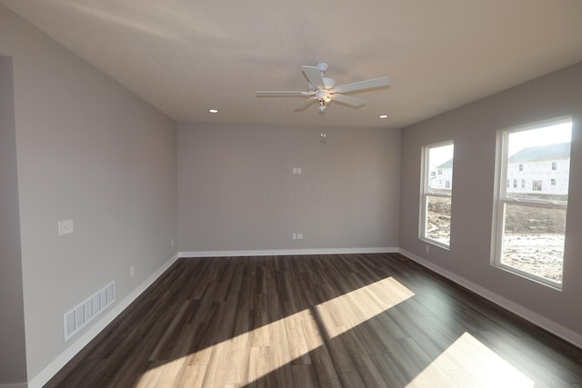 unfurnished room featuring ceiling fan, recessed lighting, wood finished floors, visible vents, and baseboards