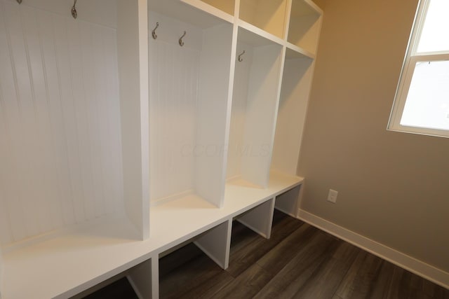 mudroom with dark wood-type flooring and baseboards