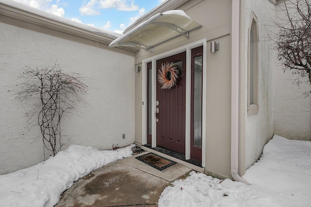 view of snow covered property entrance