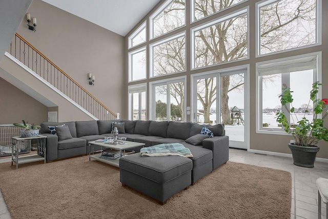 tiled living room with plenty of natural light and a high ceiling