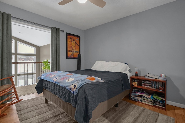 bedroom with lofted ceiling, ceiling fan, and light wood-type flooring