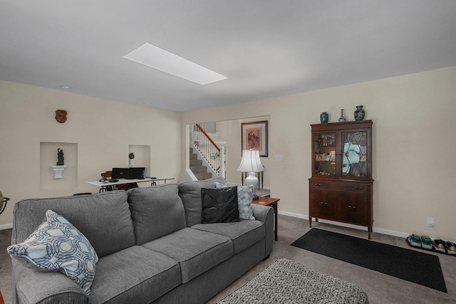 living room with a skylight and carpet