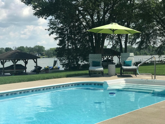 view of swimming pool with a gazebo and a lawn