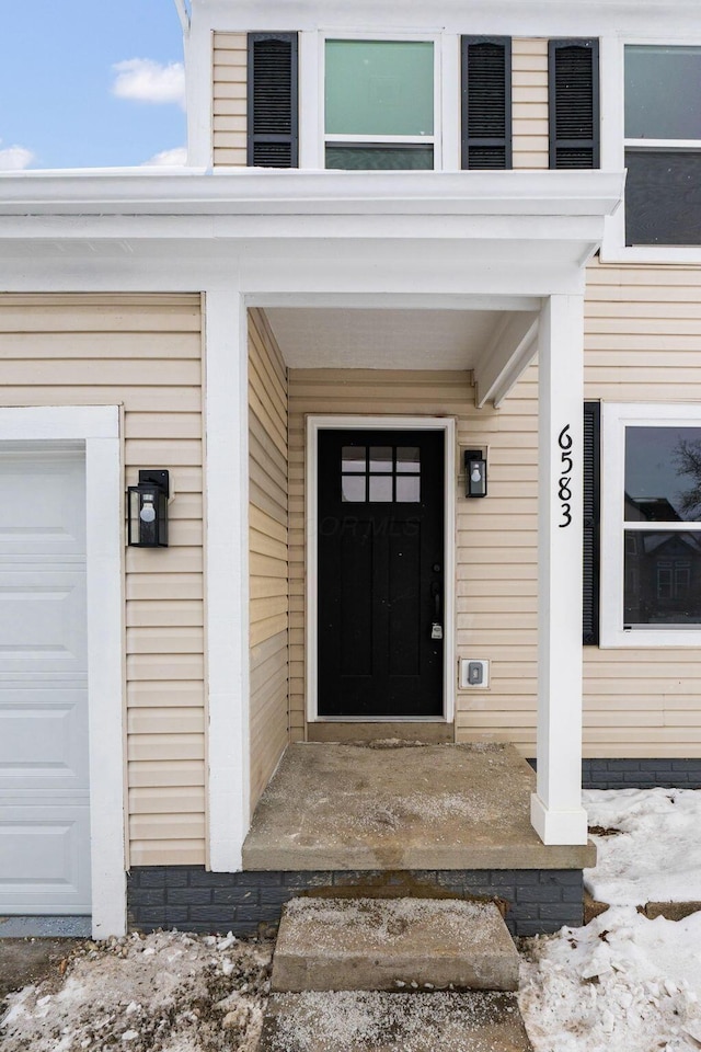 view of exterior entry with a garage