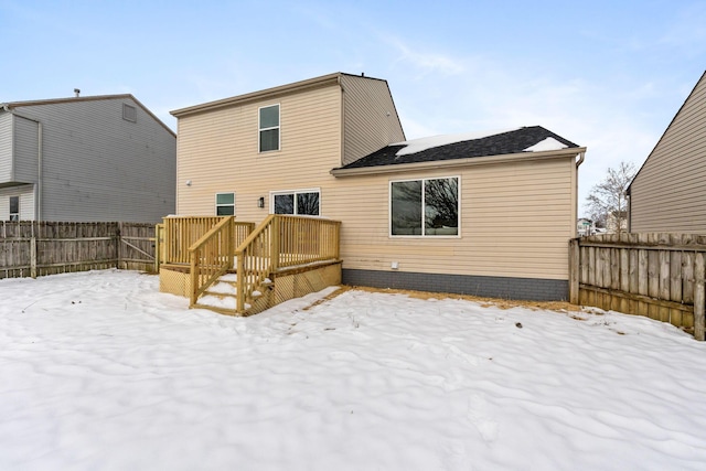 snow covered property featuring a deck