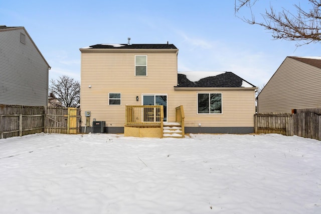 snow covered rear of property with cooling unit