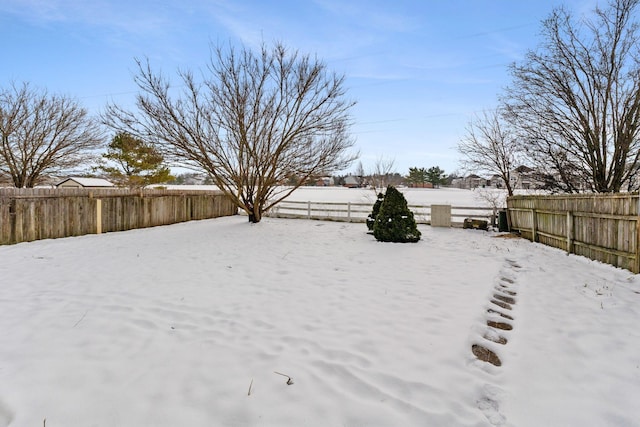 view of yard layered in snow