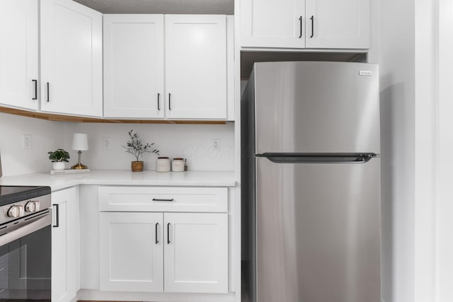 kitchen with white cabinetry and appliances with stainless steel finishes