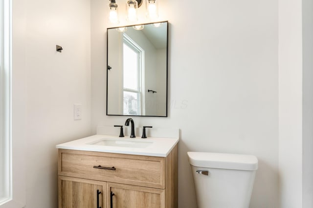 bathroom with toilet and vanity