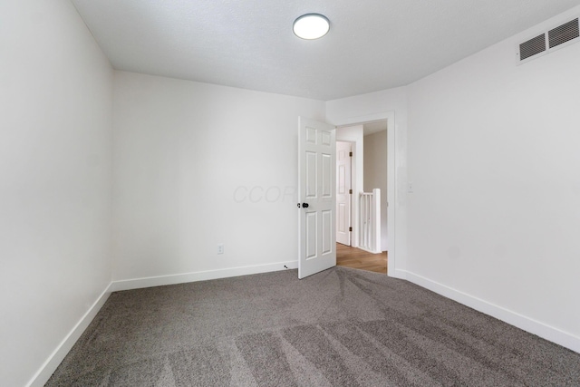 empty room with dark carpet