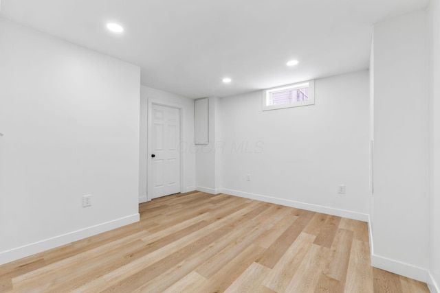 basement with light hardwood / wood-style flooring