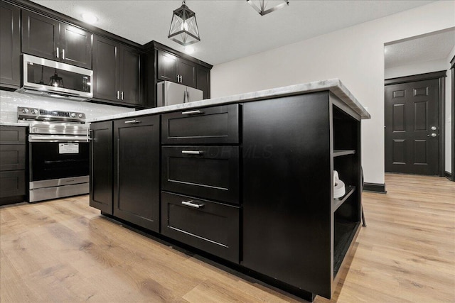 kitchen with light hardwood / wood-style floors and stainless steel appliances