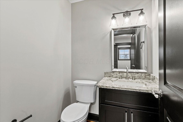 bathroom with toilet and vanity