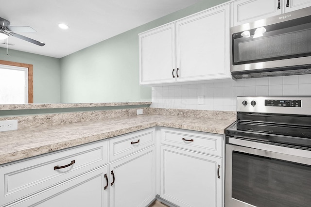 kitchen with ceiling fan, decorative backsplash, light countertops, white cabinets, and stainless steel appliances