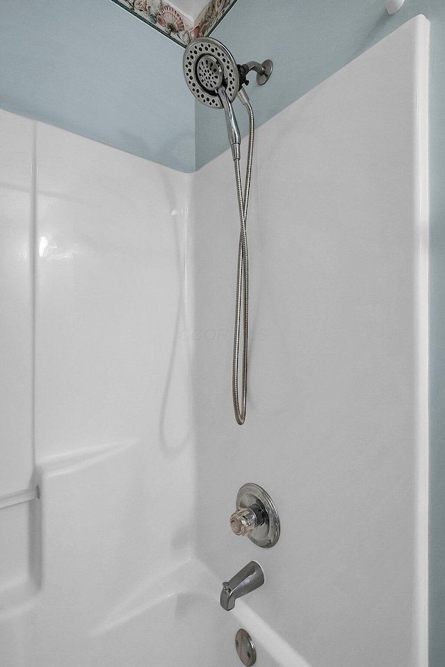 interior details featuring bathtub / shower combination