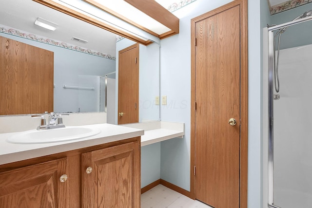 bathroom featuring an enclosed shower and vanity