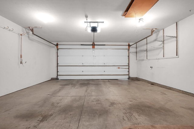 garage with baseboards and a garage door opener