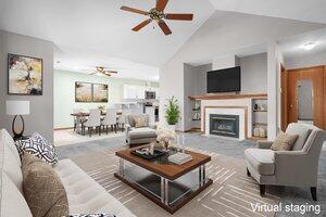 living room with lofted ceiling, a fireplace, and a ceiling fan