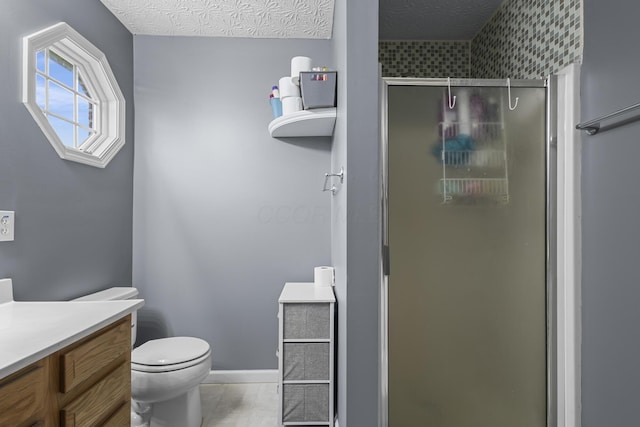 bathroom featuring toilet, tile patterned floors, an enclosed shower, a textured ceiling, and vanity