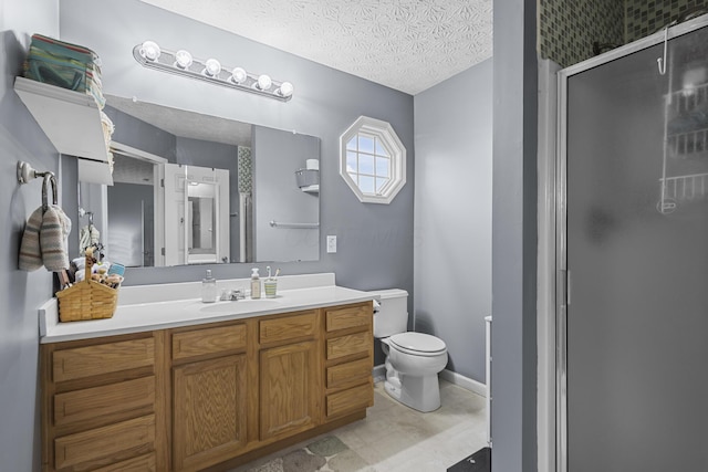 bathroom with a textured ceiling, an enclosed shower, vanity, and toilet