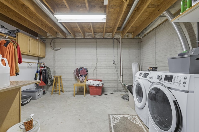 washroom featuring washing machine and dryer and cabinets