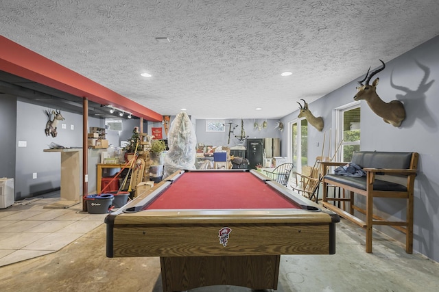 playroom with a textured ceiling and pool table