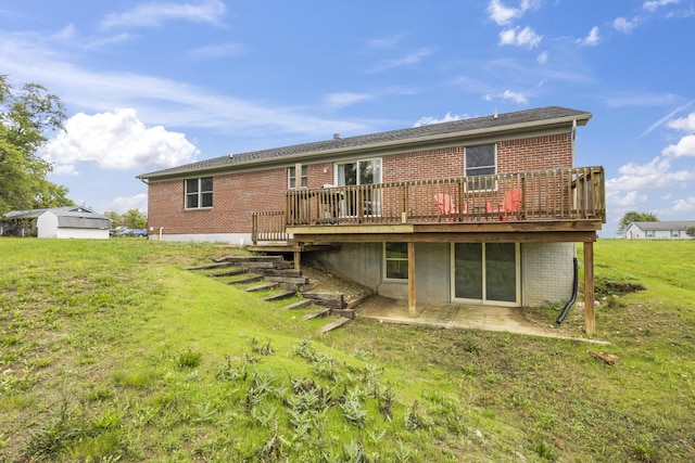 back of property featuring a deck, a patio, and a yard